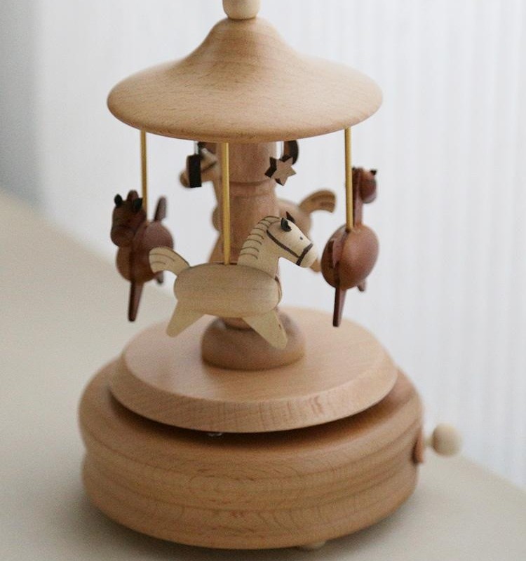 A wooden music box resembling a carousel